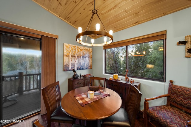 dining space with vaulted ceiling, wood ceiling, and an inviting chandelier