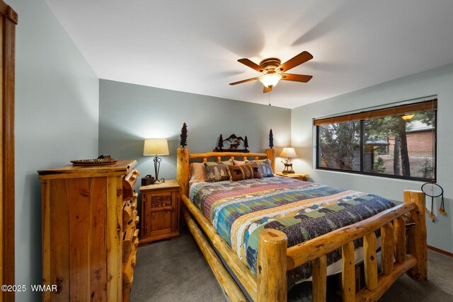 bedroom featuring a ceiling fan and dark carpet