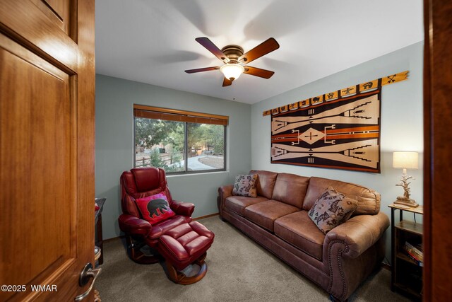 living area with carpet and a ceiling fan