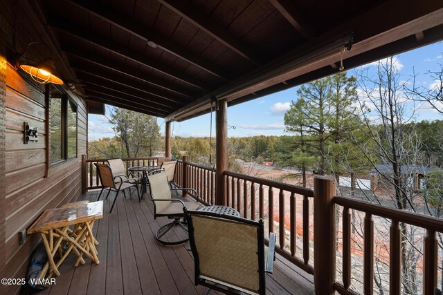 wooden terrace featuring outdoor dining area