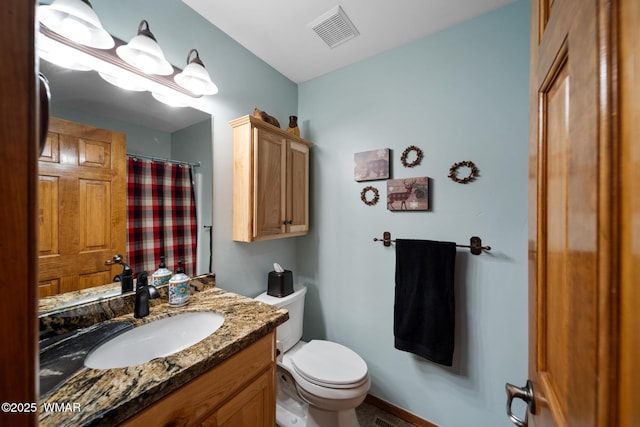 full bath with toilet, vanity, and visible vents