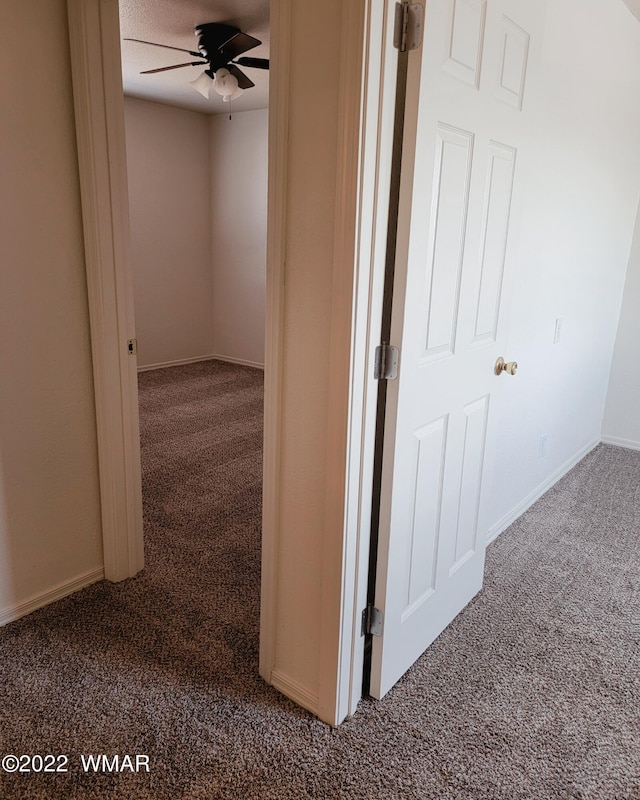 hallway with carpet and baseboards