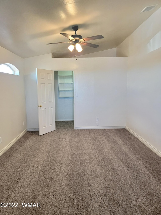 unfurnished bedroom with carpet floors, baseboards, visible vents, and a ceiling fan