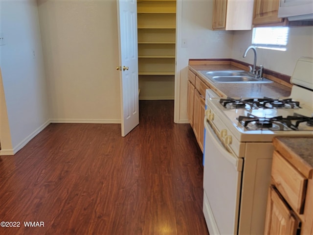 kitchen featuring dark wood-style floors, white range with gas cooktop, light brown cabinets, and a sink