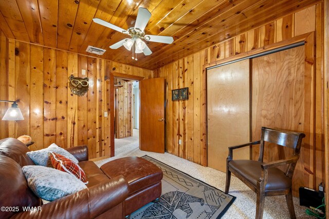 2 Acr 1027, Greer, AZ 85927 - carpeted living area featuring wood ceiling, wooden walls, and ceiling fan