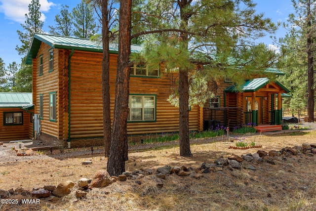 2 Acr 1027, Greer, AZ 85927 - view of front of house with metal roof, a standing seam roof, and log siding