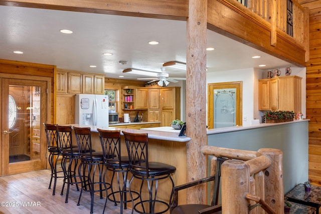 2 Acr 1027, Greer, AZ 85927 - kitchen with white fridge with ice dispenser, recessed lighting, light countertops, light wood finished floors, and a breakfast bar area