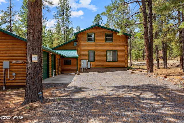 2 Acr 1027, Greer, AZ 85927 - back of property featuring gravel driveway and metal roof