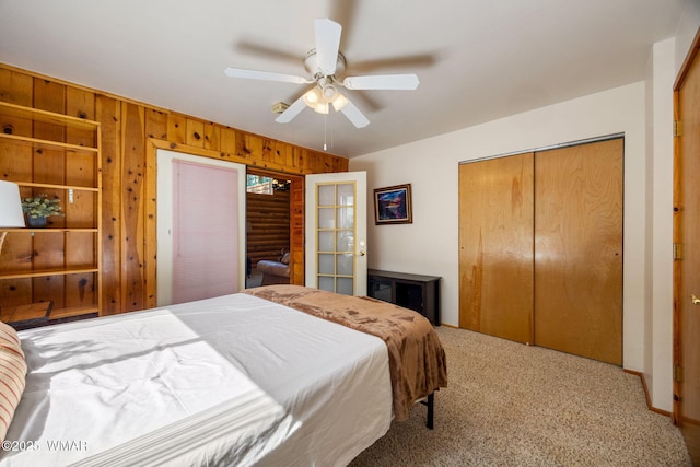 2 Acr 1027, Greer, AZ 85927 - bedroom featuring wood walls, carpet flooring, a ceiling fan, a closet, and french doors