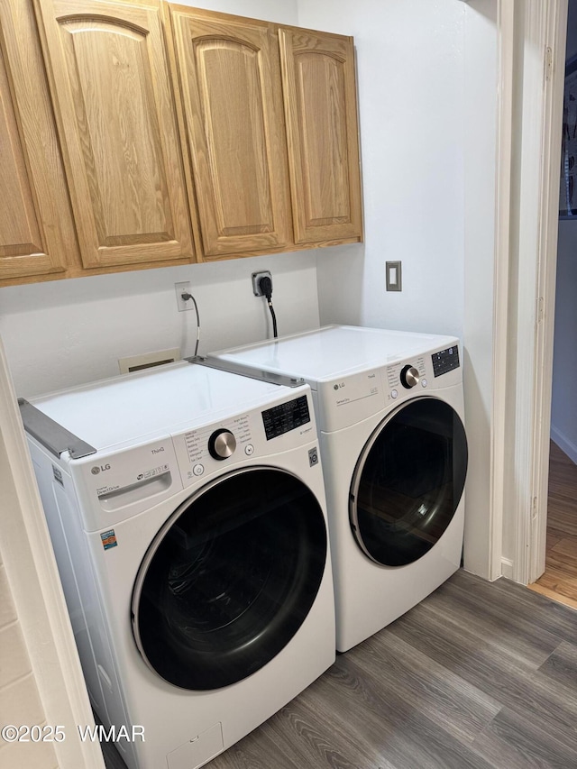 323 N Woodland Rd, Lakeside, AZ 85929 - laundry area featuring washing machine and clothes dryer, cabinet space, and wood finished floors