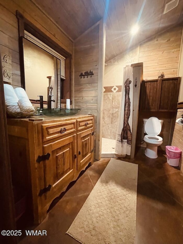 4971 Buck Springs Rd, Pinetop, AZ 85935 - full bathroom with visible vents, wood walls, toilet, and lofted ceiling