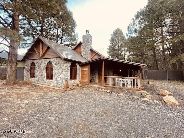 4971 Buck Springs Rd, Pinetop, AZ 85935 - chalet / cabin featuring metal roof, stone siding, a chimney, and fence