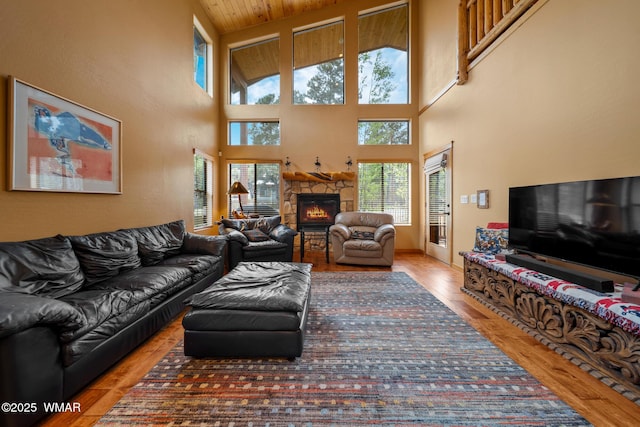 2011 N Lake Breeze Rd, Lakeside, AZ 85929 - living area featuring wood finished floors, a fireplace, and a towering ceiling