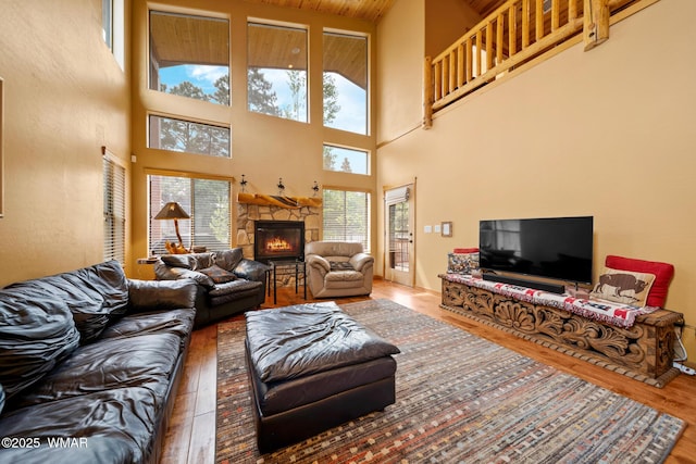 2011 N Lake Breeze Rd, Lakeside, AZ 85929 - living area featuring wood finished floors, a towering ceiling, and a stone fireplace