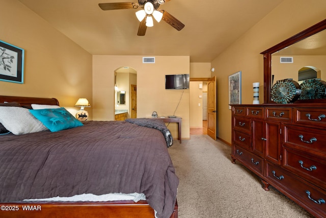 2011 N Lake Breeze Rd, Lakeside, AZ 85929 - bedroom featuring arched walkways, light carpet, ensuite bathroom, baseboards, and a ceiling fan