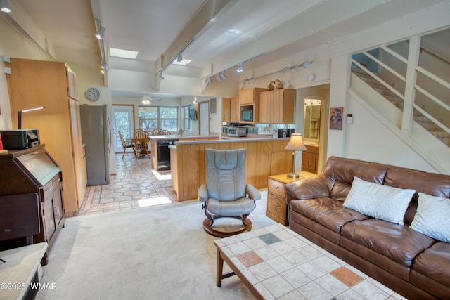 5029 Show Low Lake Rd, Show Low, AZ 85901 - living area featuring track lighting, a skylight, stairway, and light carpet