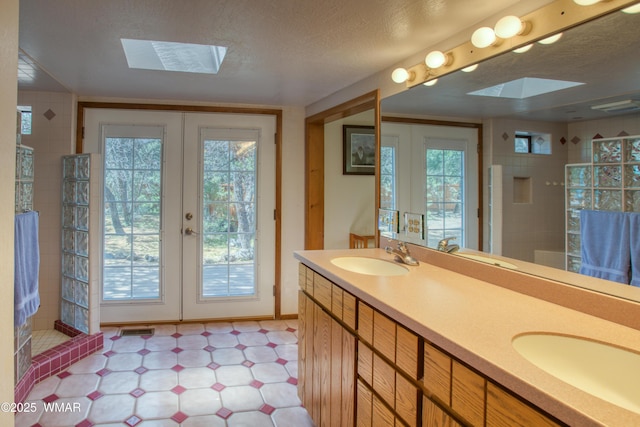 5029 Show Low Lake Rd, Show Low, AZ 85901 - full bath with a skylight, french doors, tile patterned floors, walk in shower, and double vanity