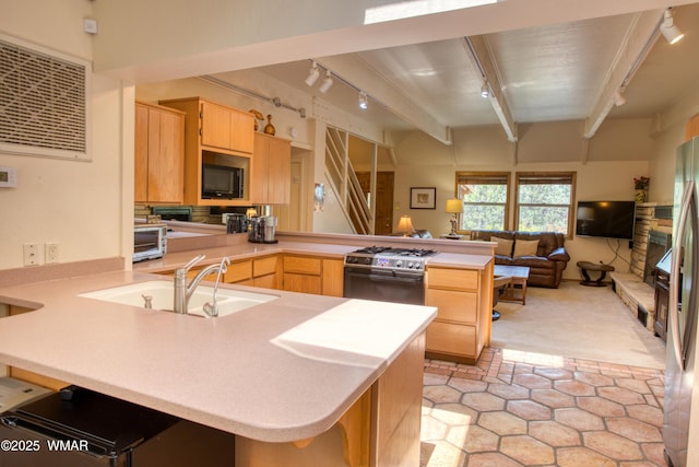 5029 Show Low Lake Rd, Show Low, AZ 85901 - kitchen with track lighting, a peninsula, stainless steel stove, light brown cabinetry, and beamed ceiling