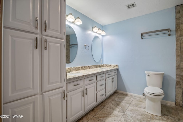 full bathroom featuring visible vents, a sink, baseboards, and double vanity