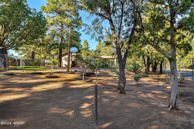 view of community featuring community basketball court and fence