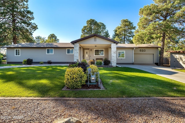 ranch-style home with a porch, a garage, a front yard, and concrete driveway