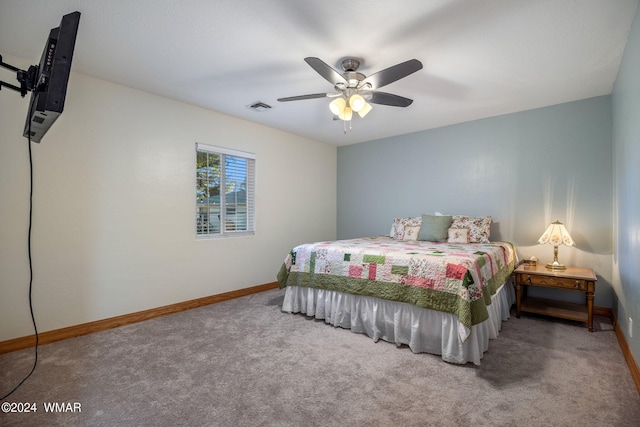 carpeted bedroom featuring ceiling fan, visible vents, and baseboards