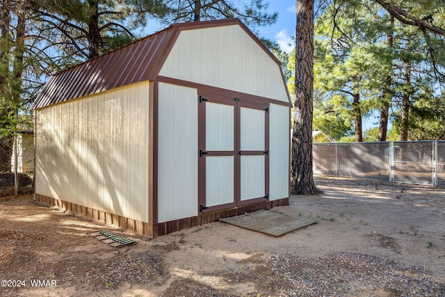 view of shed with fence