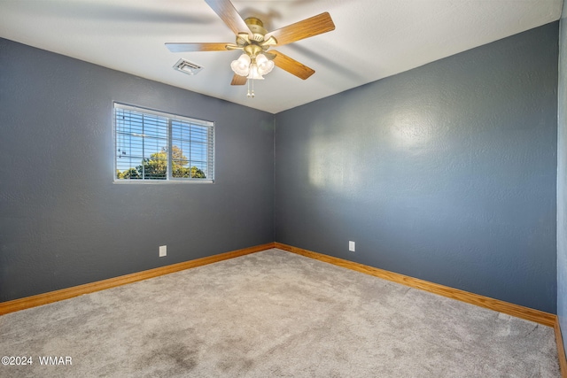 empty room with a ceiling fan, baseboards, visible vents, and carpet flooring