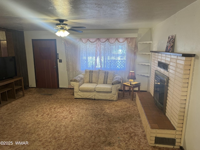 living room featuring visible vents, a fireplace, dark carpet, and a textured ceiling