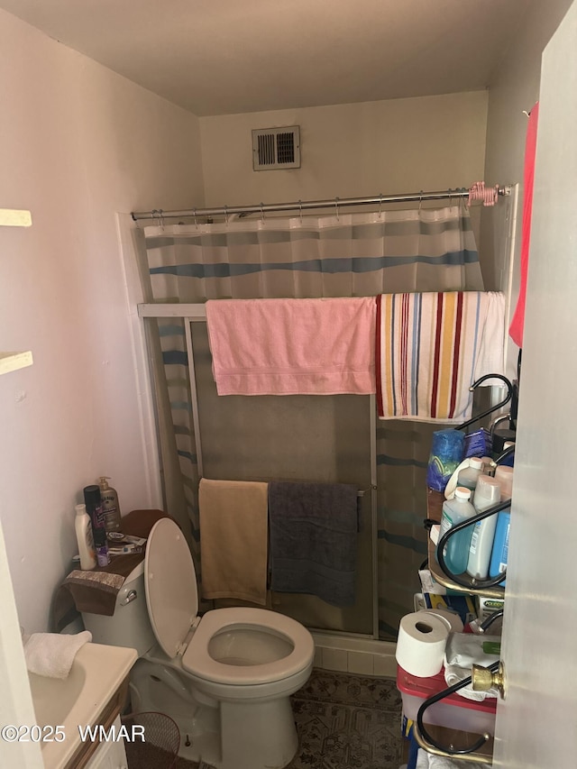 bathroom featuring visible vents, toilet, a shower stall, vanity, and tile patterned flooring