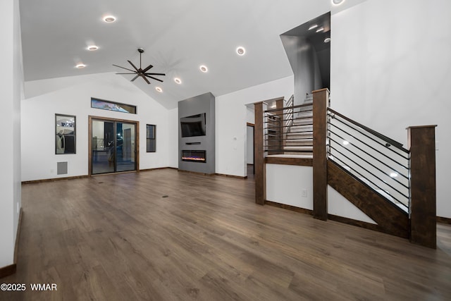 2872 Penny Ln, Lakeside, AZ 85929 - unfurnished living room featuring stairs, recessed lighting, wood finished floors, baseboards, and a glass covered fireplace