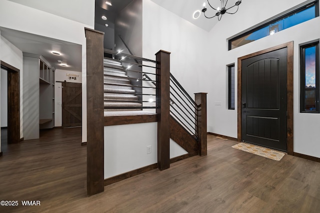 2872 Penny Ln, Lakeside, AZ 85929 - foyer featuring a barn door, a towering ceiling, stairs, baseboards, and wood finished floors