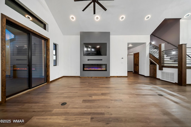 2872 Penny Ln, Lakeside, AZ 85929 - unfurnished living room with a fireplace, wood finished floors, stairs, lofted ceiling, and baseboards