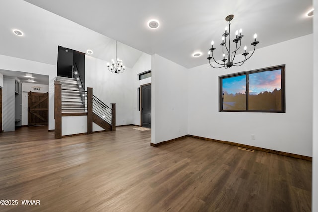 2872 Penny Ln, Lakeside, AZ 85929 - empty room featuring a chandelier, stairs, baseboards, wood finished floors, and lofted ceiling