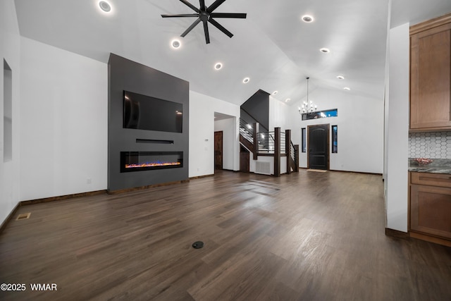 2872 Penny Ln, Lakeside, AZ 85929 - unfurnished living room featuring a large fireplace, a ceiling fan, a chandelier, dark wood-style floors, and high vaulted ceiling
