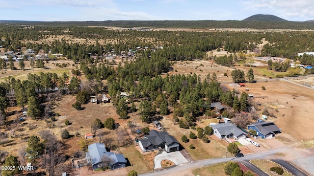 2872 Penny Ln, Lakeside, AZ 85929 - aerial overview of property's location with a heavily wooded area, nearby suburban area, and a mountain backdrop