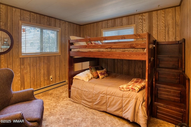 carpeted bedroom featuring a baseboard heating unit and wood walls