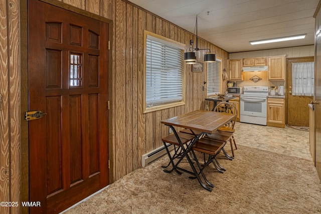 carpeted dining room with wood walls