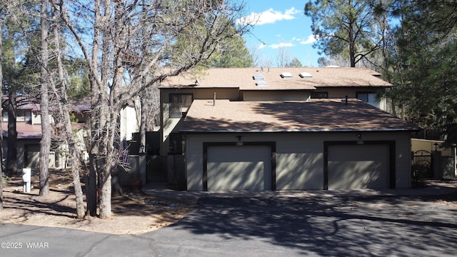 view of side of property with a garage and driveway