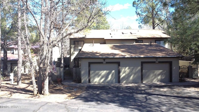 view of front of house with a garage and fence