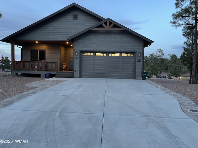540 S Mountain Pines Ave, Show Low, AZ 85901 - view of front of house with concrete driveway, an attached garage, and covered porch
