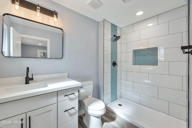 261 S 5th Pl, Show Low, AZ 85901 - full bathroom with vanity, wood finished floors, a tile shower, and recessed lighting