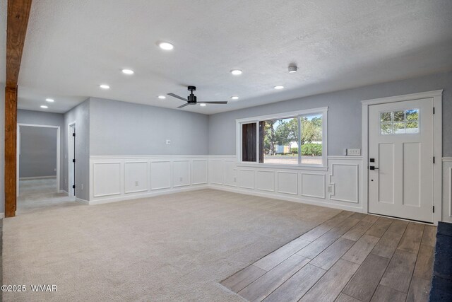 261 S 5th Pl, Show Low, AZ 85901 - entryway featuring wood finished floors, ceiling fan, recessed lighting, wainscoting, and a decorative wall