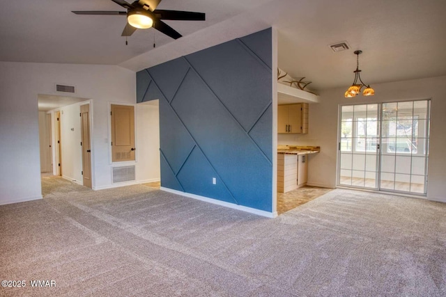 unfurnished living room with vaulted ceiling, a ceiling fan, light colored carpet, and baseboards