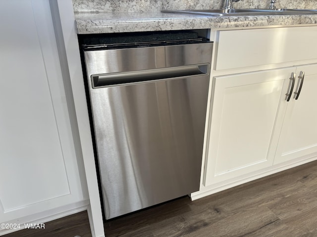 interior details featuring dark wood finished floors, white cabinetry, dishwasher, and a sink