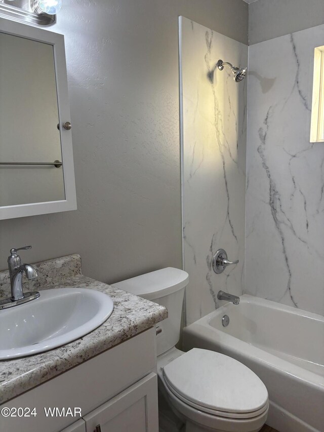 bathroom featuring toilet, shower / washtub combination, and vanity