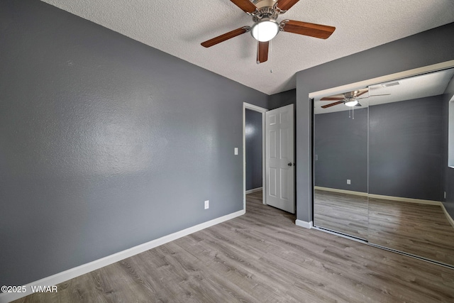 236 E 6th St, Eagar, AZ 85925 - unfurnished bedroom with wood finished floors, a textured ceiling, a closet, and ceiling fan