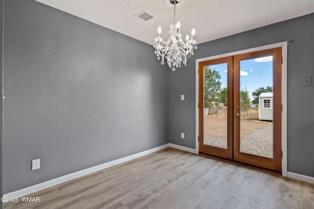 236 E 6th St, Eagar, AZ 85925 - unfurnished room featuring french doors, wood finished floors, a chandelier, and a textured ceiling