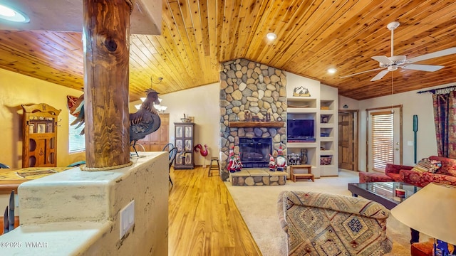 living area with wood finished floors, a stone fireplace, wood ceiling, ceiling fan, and vaulted ceiling