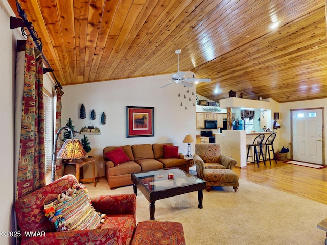 living area featuring light carpet, wood ceiling, light wood-style floors, and vaulted ceiling